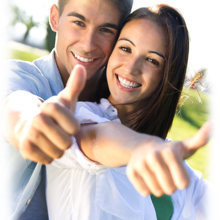 Happy young couple having fun in a park